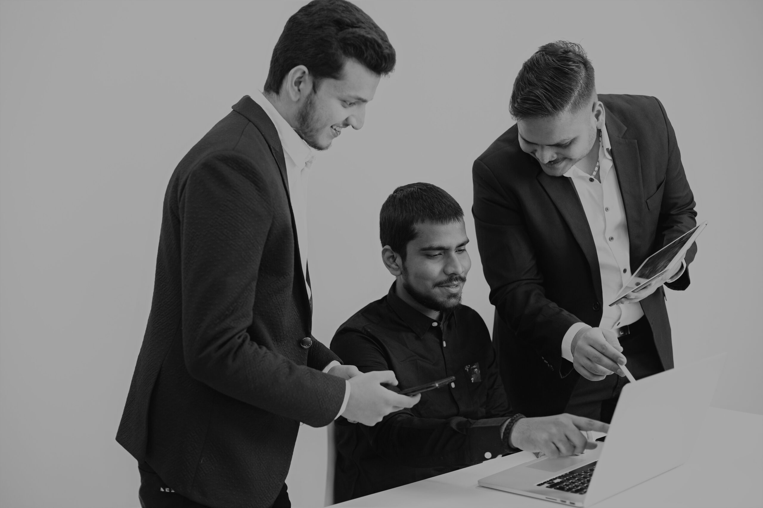 Isolated. Three neb discussing ideas. White background. Indian nationality.